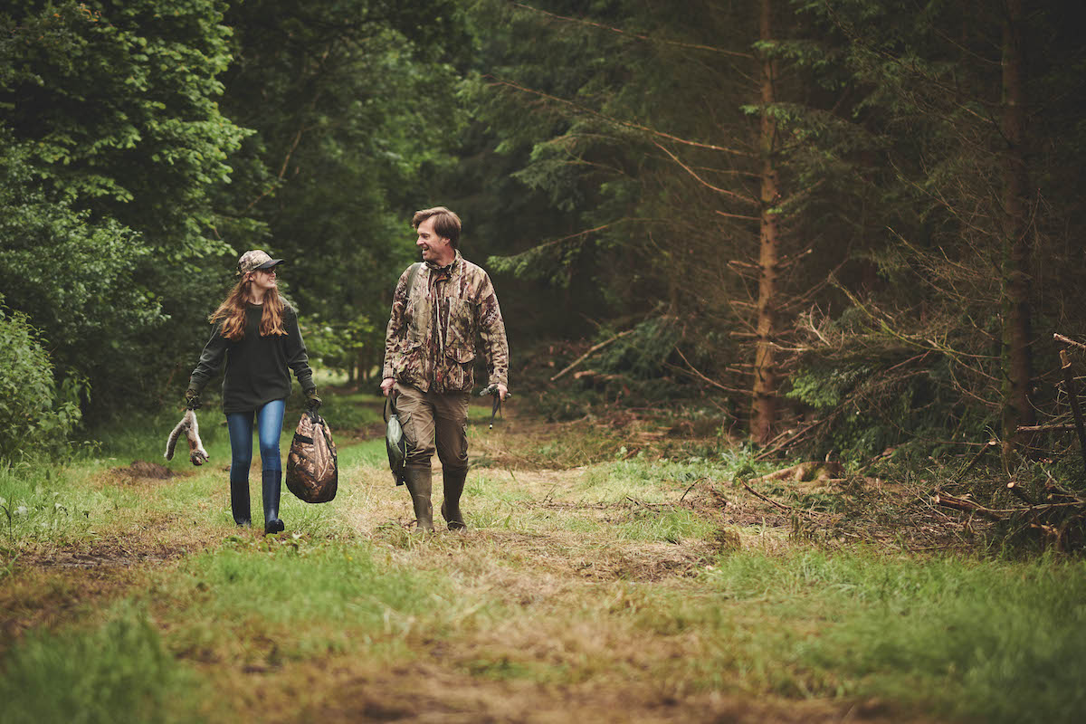 Girl and father squirrel hunting